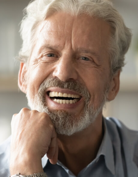 woman smiling after getting dentures in Norwood