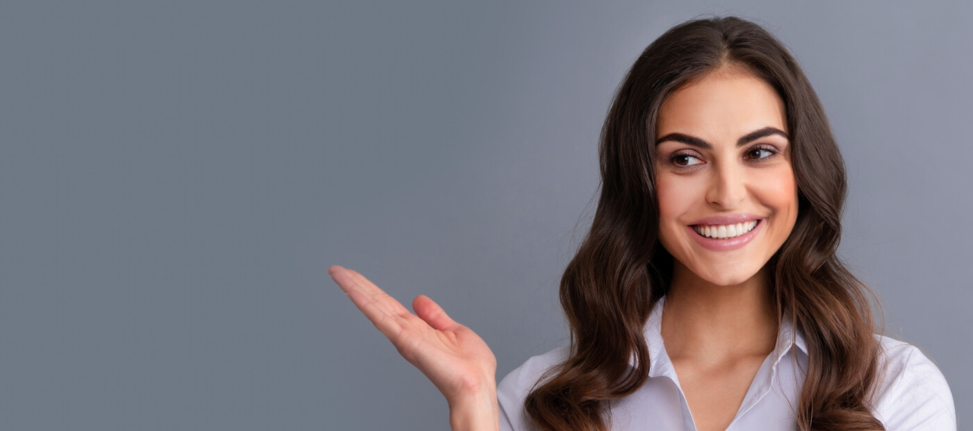 Brunette woman grinning after a smile makeover in Norwood