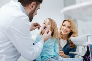 Family dentist doing an exam