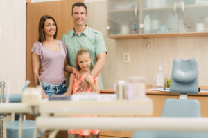 Happy family visiting new family dentist in Norwood