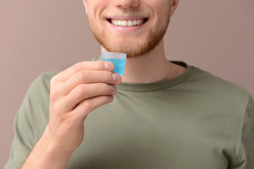 Person rinses with mouthwash before visiting their dentist in Norwood.