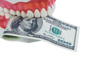 Dental mold biting $100 bill
